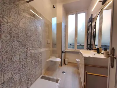 a bathroom with a shower and a toilet and a sink at Guest House Garofano in Rome
