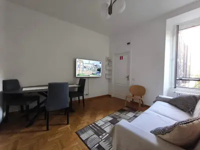 a living room with a couch and a dining room table at Guest House Garofano in Rome