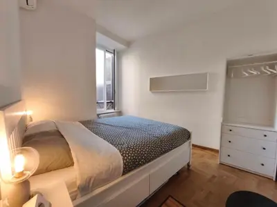a bedroom with a large bed and a window at Guest House Garofano in Rome