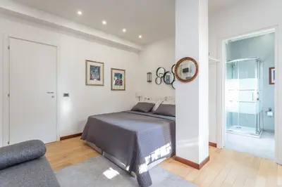 a bedroom with a bed and a mirror and a couch at Spacious 4 BDR with Parking in Rome
