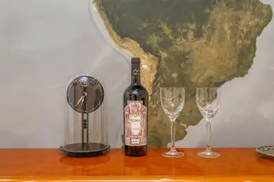 a bottle of wine and two glasses on a table at Spacious 4 BDR with Parking in Rome