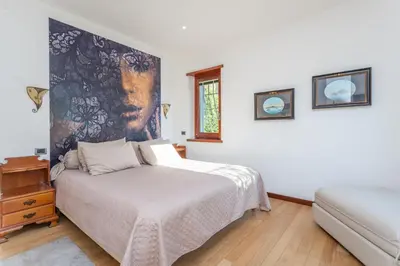 a bedroom with a bed and a couch at Spacious 4 BDR with Parking in Rome