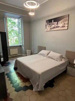 a bedroom with a large bed in a room at Appartamento Viale Trastevere in Rome
