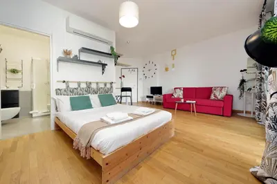 a bedroom with a large bed and a red couch at Julies Flat by DomusDimore in Rome