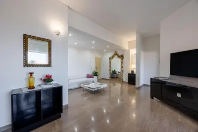 a living room with a flat screen tv and a couch at Vaticano84 Gemelli in Rome