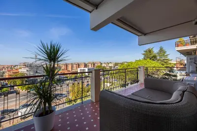 a balcony with a couch and a view of a city at Vaticano84 Gemelli in Rome