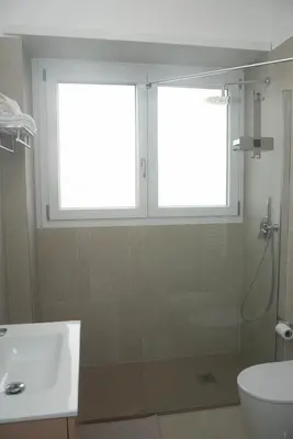 a bathroom with a shower and a sink and a window at Appartamento tra Piramide e Garbatella - Urbe Romana in Rome
