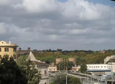 a view of a city with buildings and trees at Appartamento tra Piramide e Garbatella - Urbe Romana in Rome