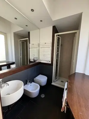 a bathroom with a sink and a toilet and a mirror at StazioneSanPietro53 in Rome