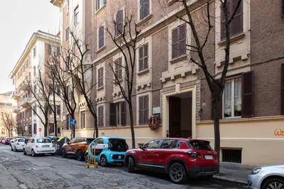 a row of cars parked on a city street at Confalonieri Place by Oneup Hospitality in Rome