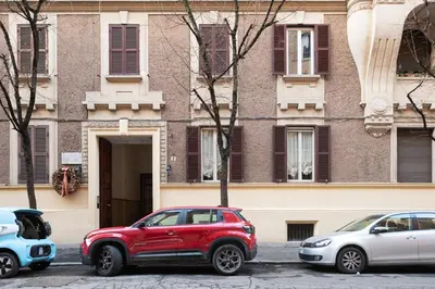 a red car parked in front of a building at Confalonieri Place by Oneup Hospitality in Rome