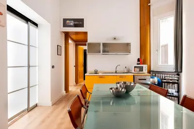 a kitchen with a glass table and chairs at Confalonieri Place by Oneup Hospitality in Rome