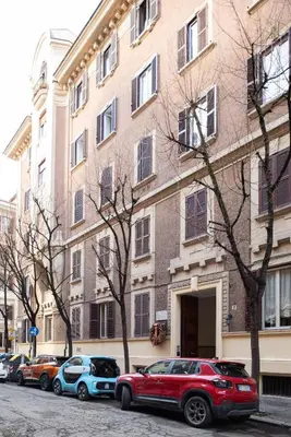 a red suv parked in front of a building at Confalonieri Place by Oneup Hospitality in Rome