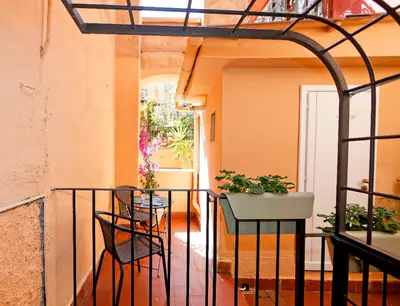 a balcony with a table and potted plants on it at Monti Suite with charming Terrace in Rome