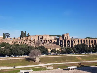 a view of a building with a park and benches at MagicHouse 2 Camere 2 Bagni -15 min Colosseo in Rome