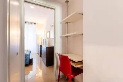 a room with a red chair and a desk at Lungotevere Aventino House by ACS HOLIDAYS in Rome