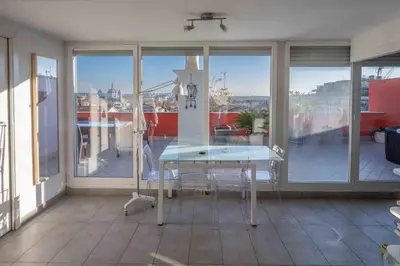 a table on a balcony with a view of a city at Farnesina Rooftop Terrace in Rome
