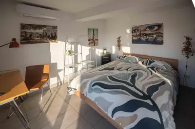 a bedroom with a bed and a desk at Farnesina Rooftop Terrace in Rome