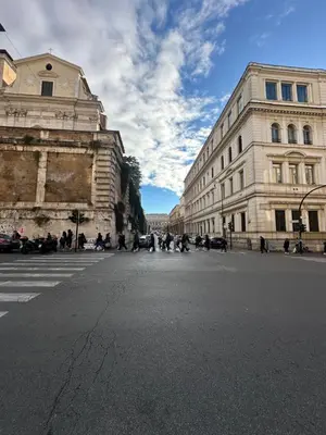 an empty street in a city with buildings at IMPERIAL suite COLOSSEUM in Rome