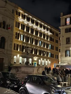a large building with cars parked in front of it at IMPERIAL suite COLOSSEUM in Rome