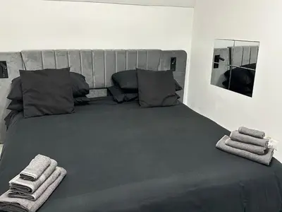 a bedroom with a large bed with towels on it at IMPERIAL suite COLOSSEUM in Rome