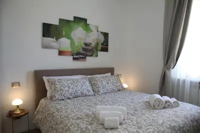 a bedroom with a bed with two towels on it at MGFCandia111 - Appartamento al Vaticano in Rome