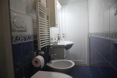 a bathroom with a white toilet and a sink at MGFCandia111 - Appartamento al Vaticano in Rome