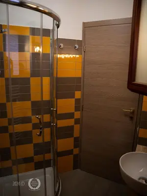 a bathroom with a shower and a sink at DeaSuites One in Rome