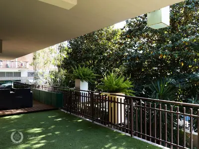 a balcony with a fence and potted plants at DeaSuites One in Rome