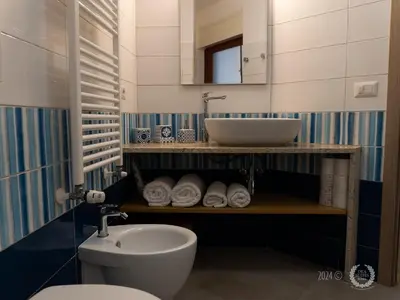 a bathroom with a sink and a toilet at DeaSuites One in Rome