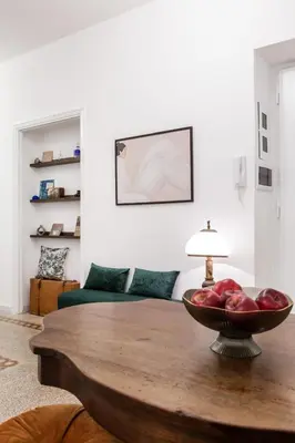 a living room with a table with a bowl of apples on it at Rome Golden Retreat in Rome