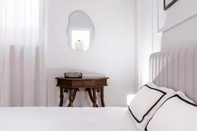 a bedroom with a bed and a table with a mirror at Rome Golden Retreat in Rome