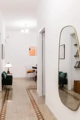 a hallway with a mirror and a living room at Rome Golden Retreat in Rome