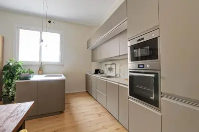 a kitchen with stainless steel appliances and a wooden floor at Boncompagni79 design & comfort in the City Center Villa Borghese in Rome