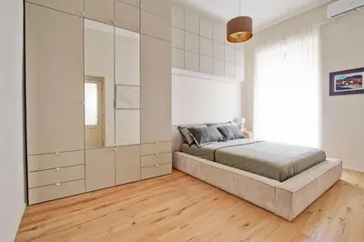 a bedroom with a bed and a large white cabinet at Boncompagni79 design & comfort in the City Center Villa Borghese in Rome