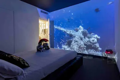 a bedroom with an aquarium with a bed in front of it at Magenta Campo dei Fiori in Rome