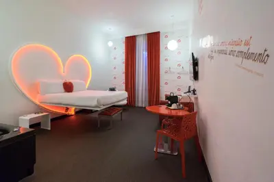 a bedroom with a bed and a desk and a table at Magenta Campo dei Fiori in Rome