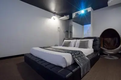 a bedroom with a bed and a leather couch at Magenta Campo dei Fiori in Rome