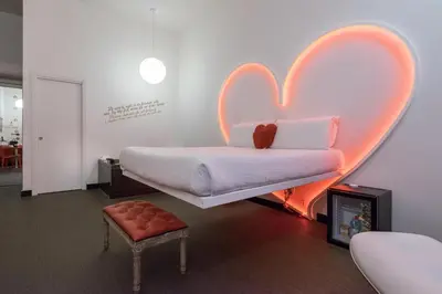 a bedroom with a bed with a heart on the wall at Magenta Campo dei Fiori in Rome