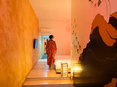 a woman walking down the stairs of a hallway at Magenta Campo dei Fiori in Rome