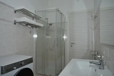 a bathroom with a glass shower and a sink at Francis house in Rome