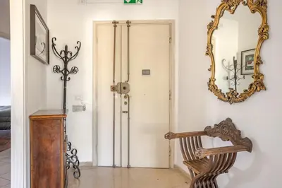 a mirror on a wall next to a door at Francis house in Rome
