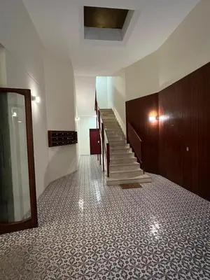 a hallway with stairs in a building with a glass door at Francis house in Rome