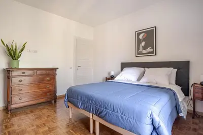 a bedroom with a bed and a wooden dresser at Francis house in Rome