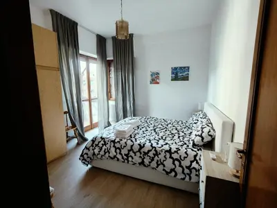 a bedroom with a bed and a desk and window at Gemelli-St Peter Sweet House in Rome