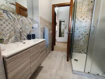 a bathroom with a sink and a shower at Gemelli-St Peter Sweet House in Rome