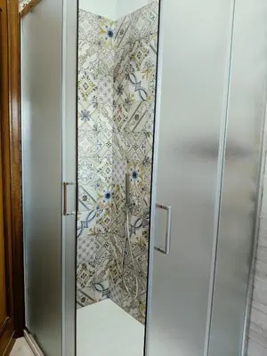 a metal elevator with a mosaic wall at Gemelli-St Peter Sweet House in Rome