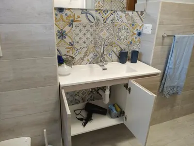 a bathroom with a sink and a shower at Gemelli-St Peter Sweet House in Rome