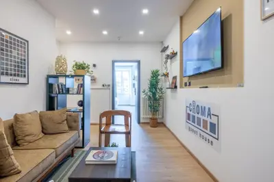 a living room with a couch and a tv on a wall at cRoma - guest house in Rome
