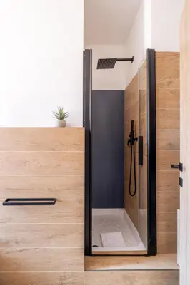 a shower with a glass door in a bathroom at cRoma - guest house in Rome